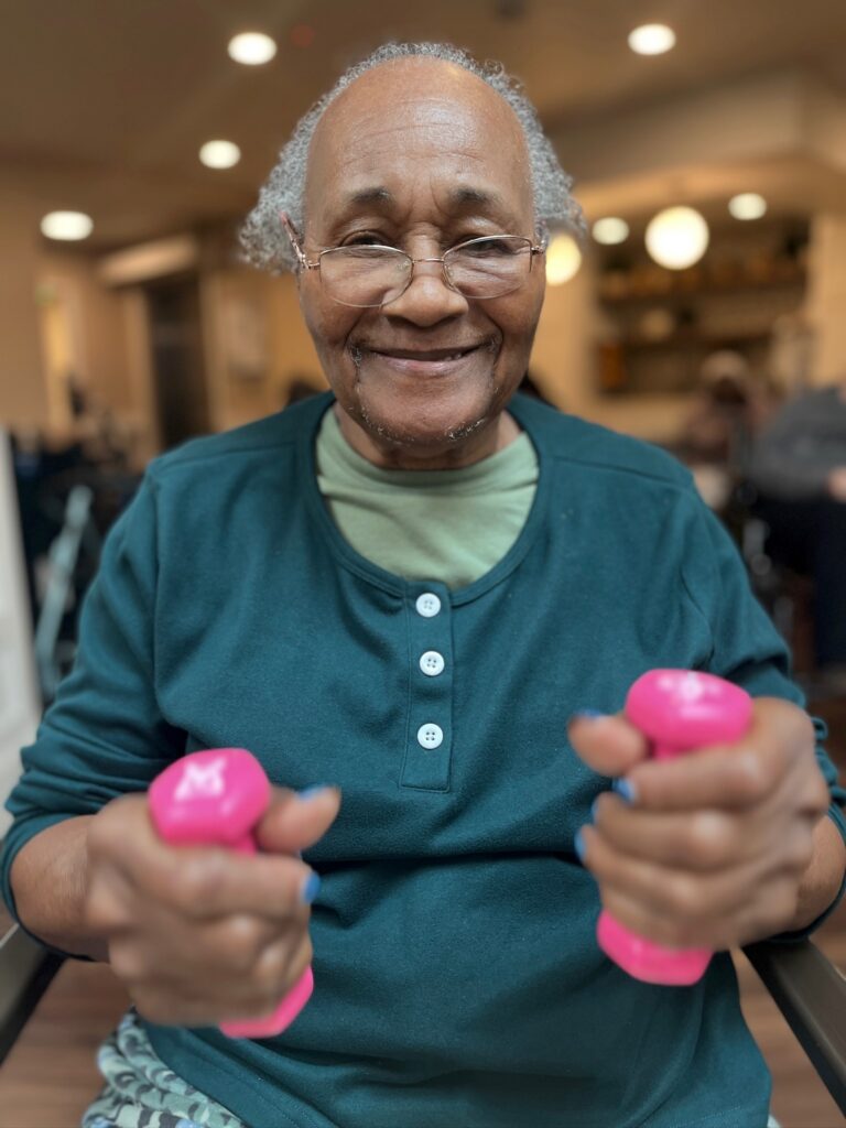 An elderly lady participating in a fitness activity at an assisted living community in Los Angeles
